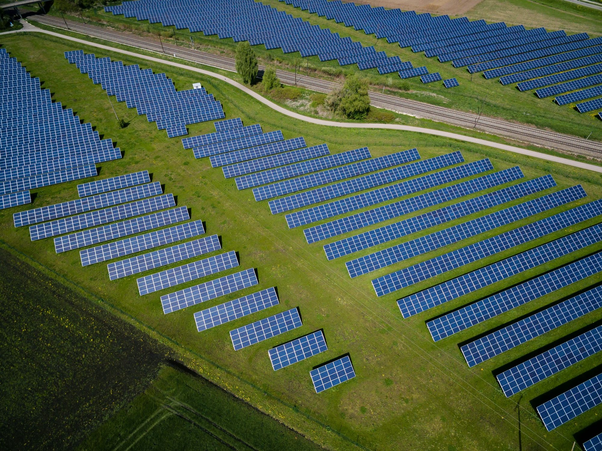 Aerial view of a solar array laid out across open ground