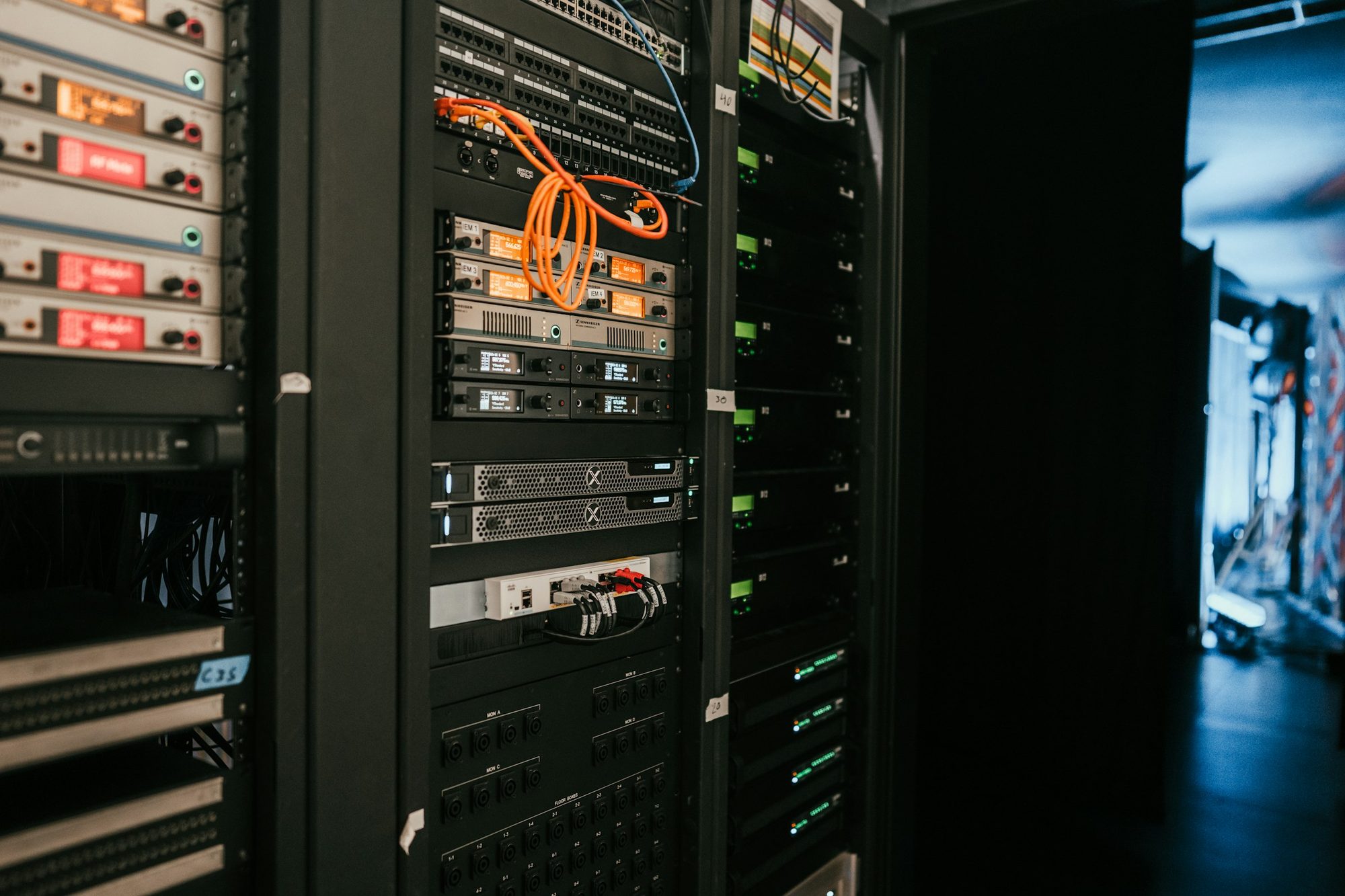 A systems room filled with racked electronic equipment